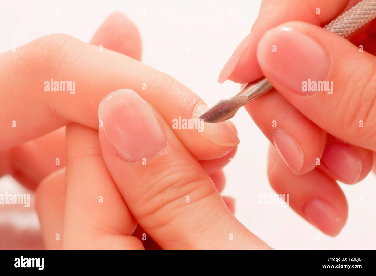 Removing cuticles at nail salon Stock Photo Alamy