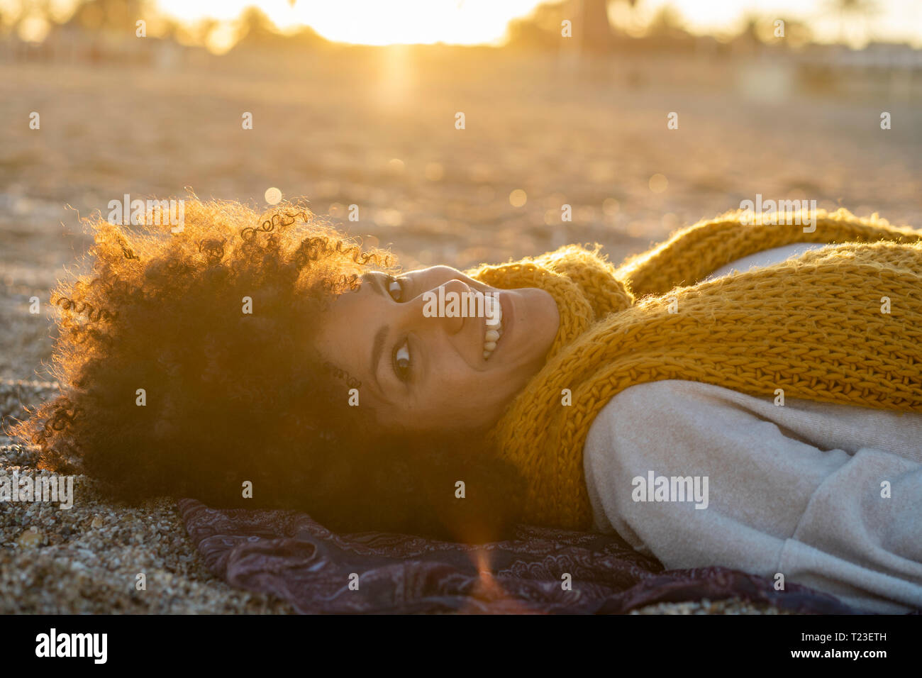 Woman lying in the sand, relaxing on the beach Stock Photo - Alamy