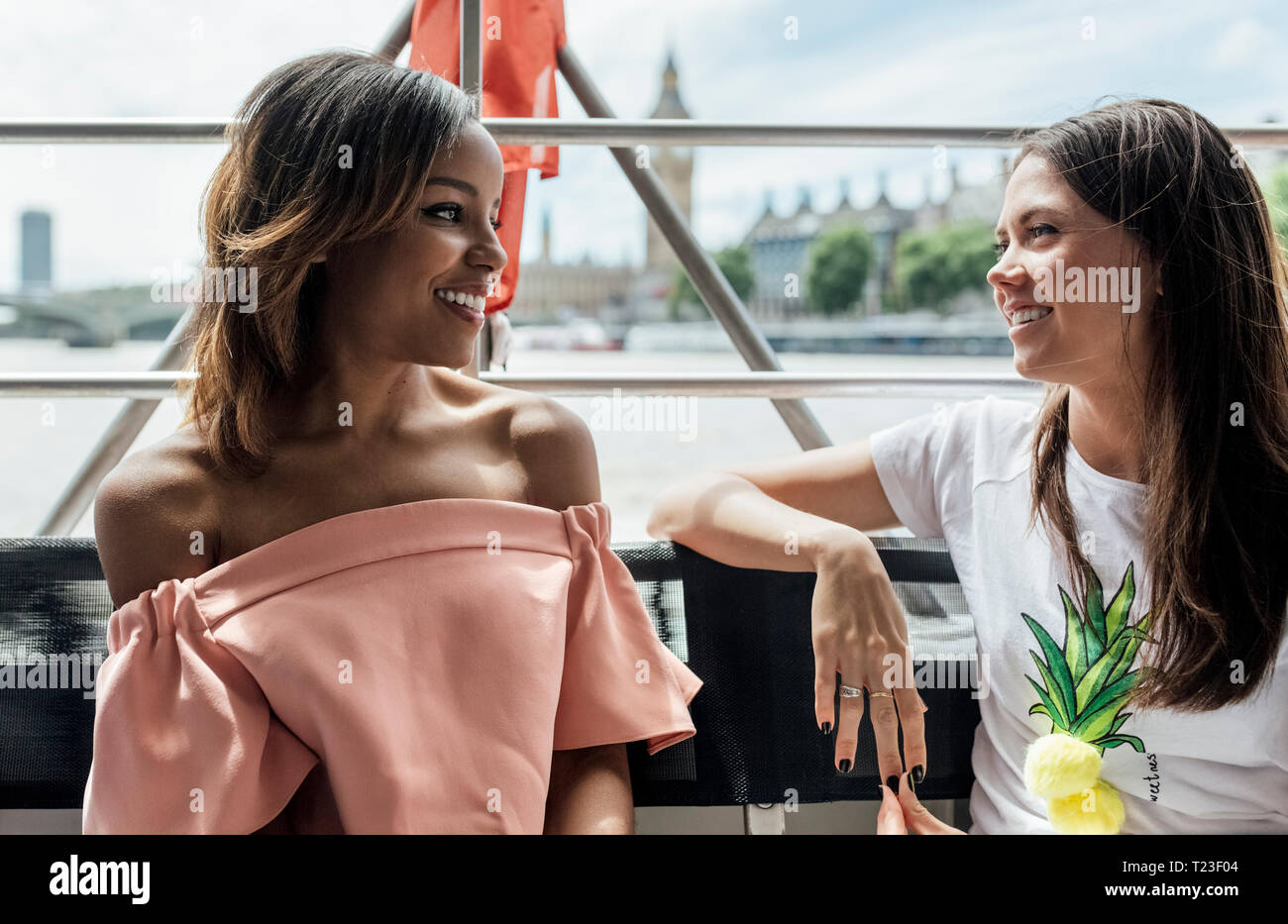 UK, London, two happy women traveling by boat on the River Thames Stock Photo