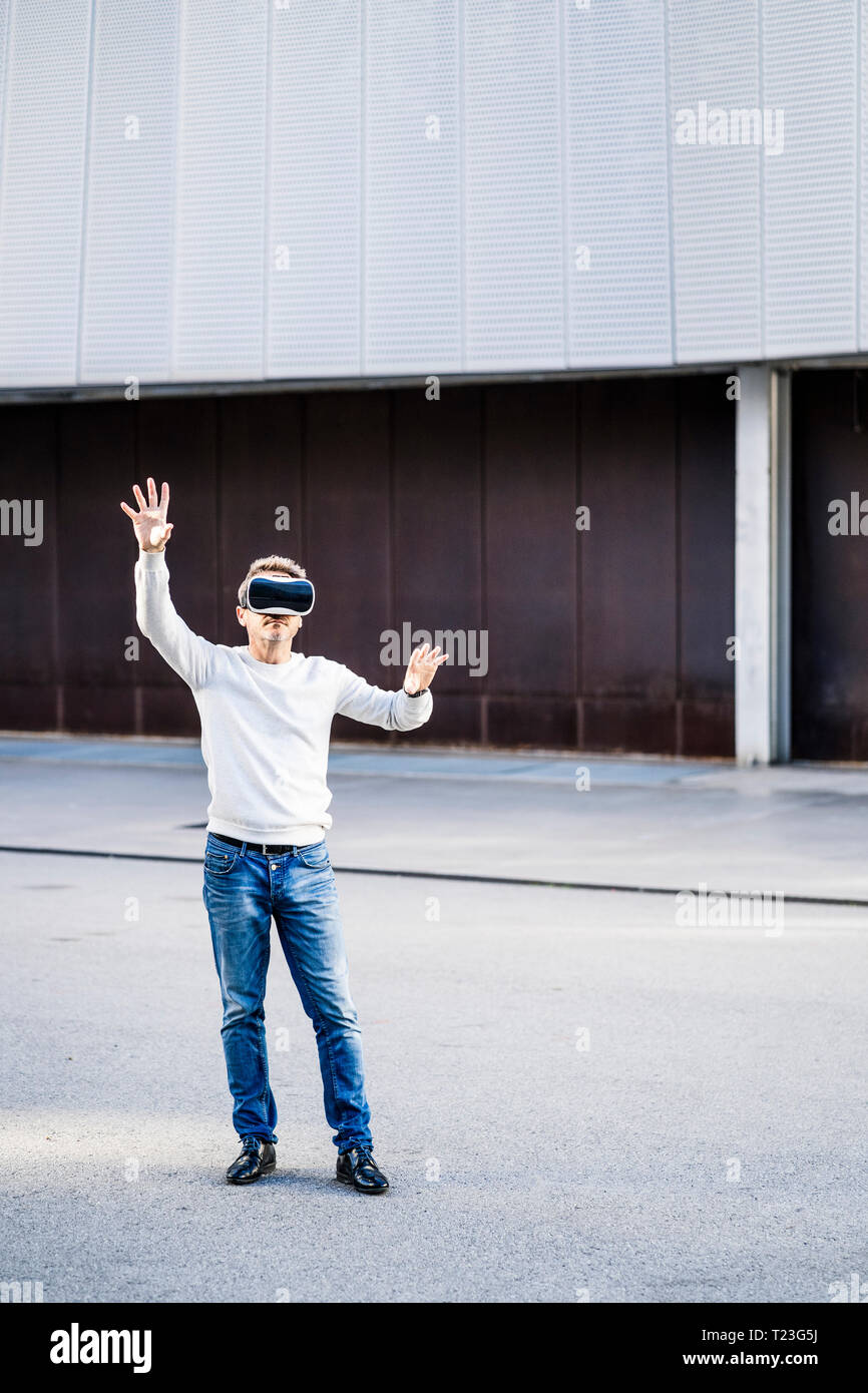 Mature man using VR glasses Stock Photo