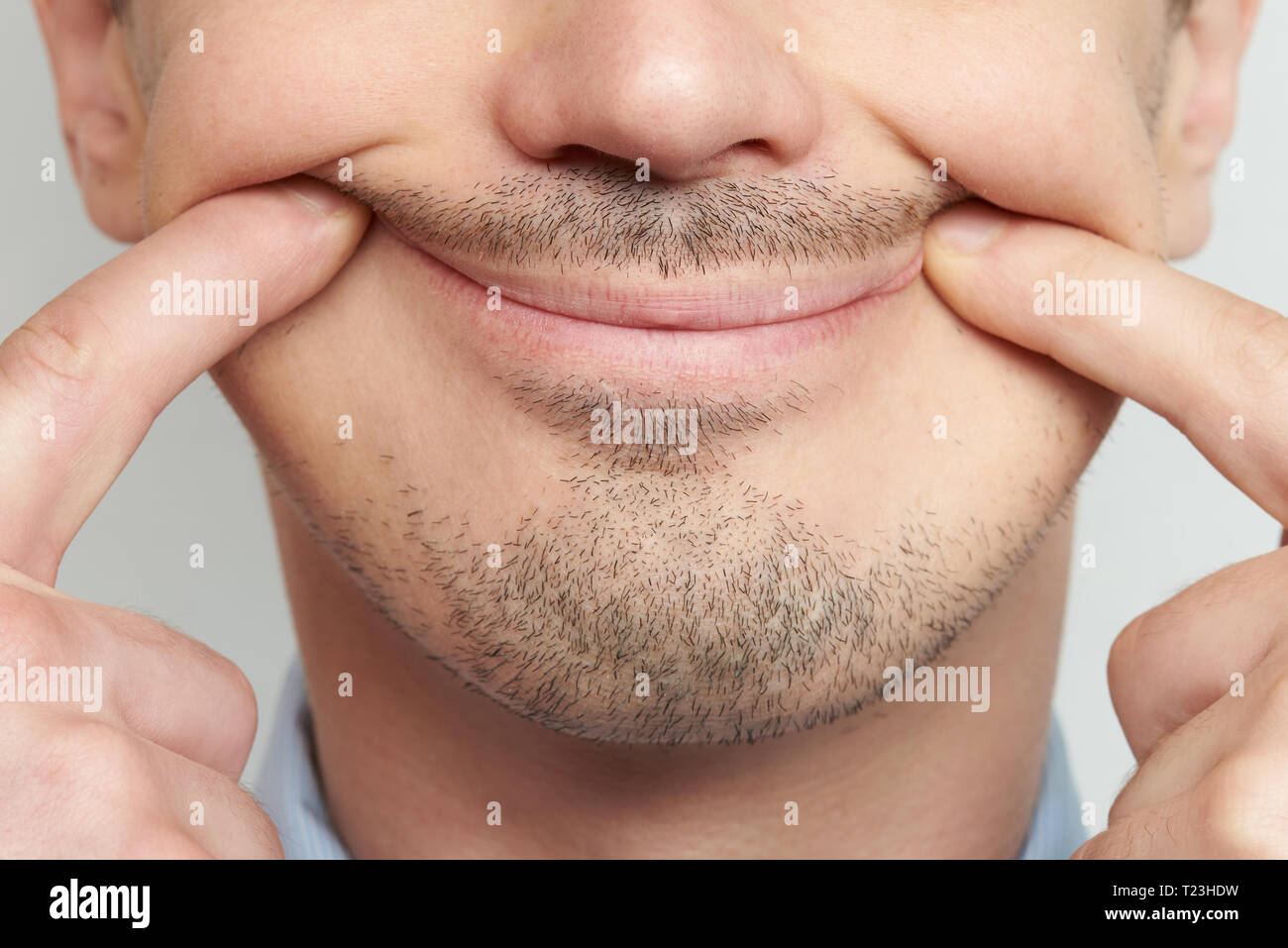 Making lips smile. Fake smile concept on man face Stock Photo