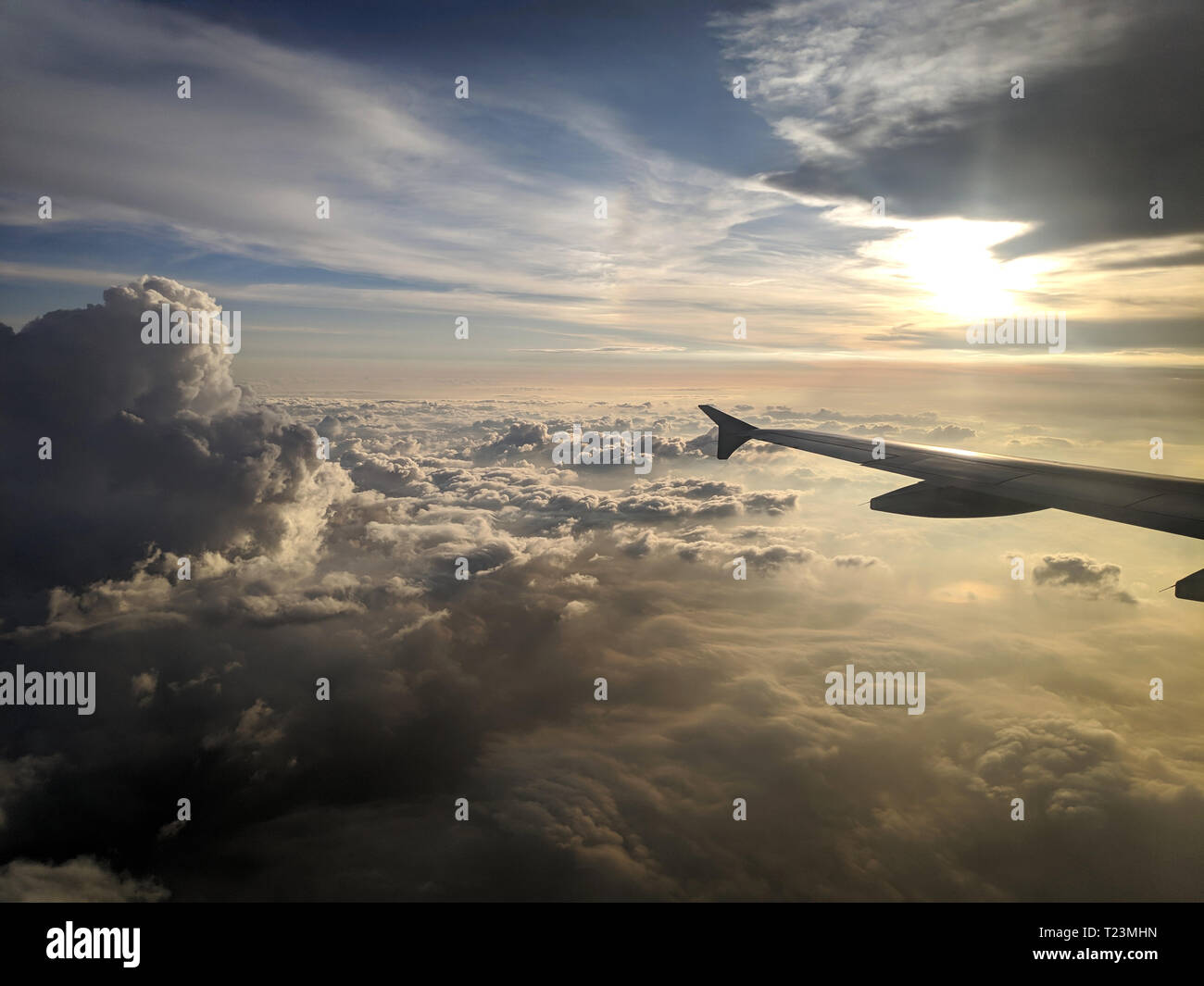 Airplane wing view out of the window on the cloudy sky Stock Photo - Alamy