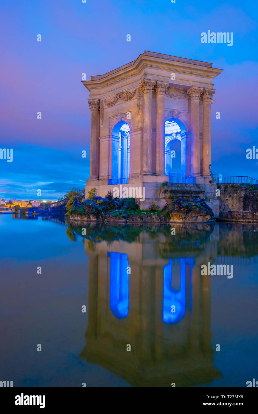 Bassin Principal de Peyrou marks end of the aqueduct in Montpellier, France. Beautiful picture of classical architecture at colorful sunset Stock Photo