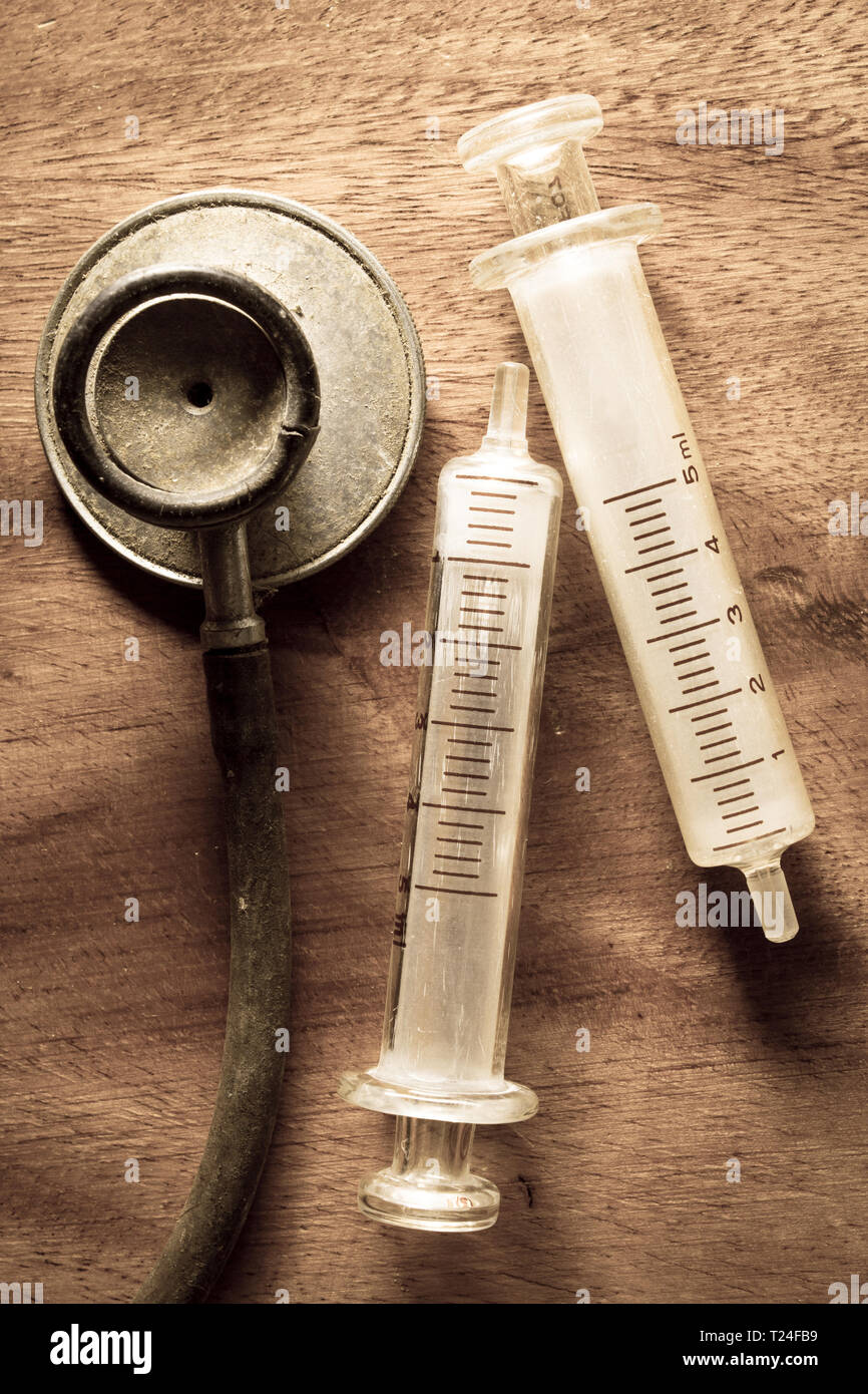 Antique stethoscope with syringes,vintage color. Stock Photo
