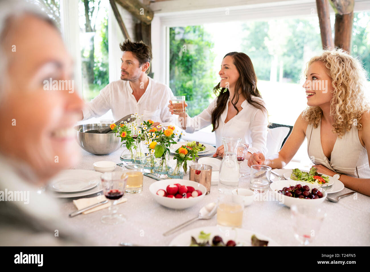 Happy family having meal together Stock Photo