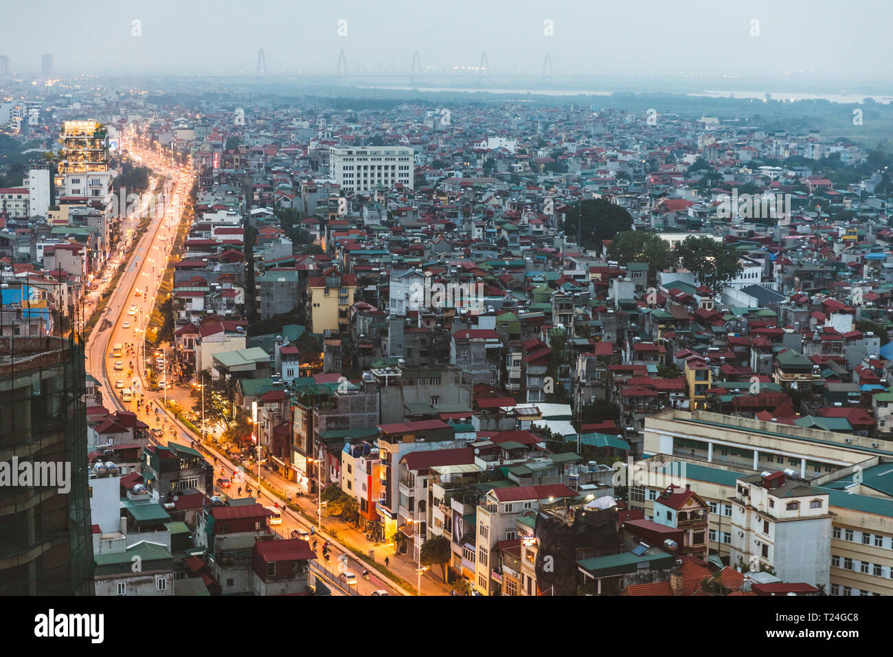 Vietnam, Hanoi, panoramic view of the city at dusk, with illuminated main road and dark residential areas Stock Photo