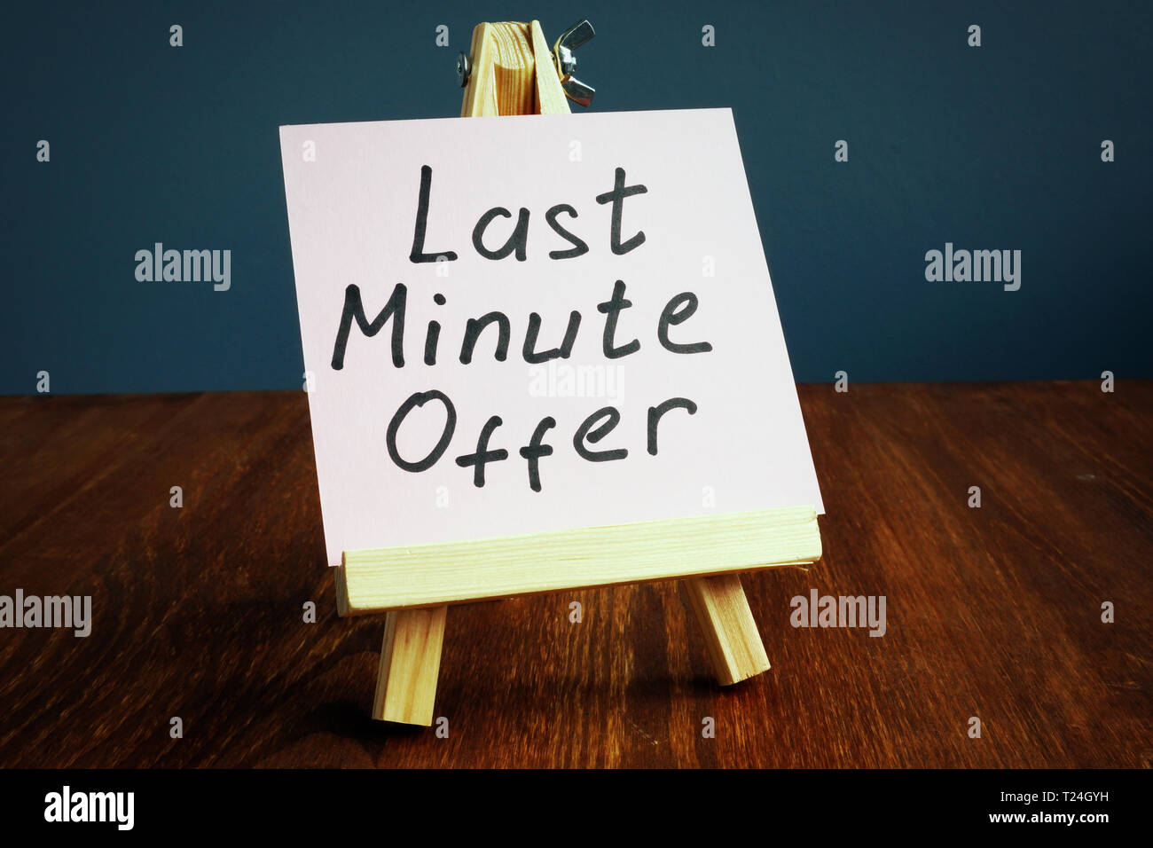 Last minute offer written on piece of paper. Stock Photo