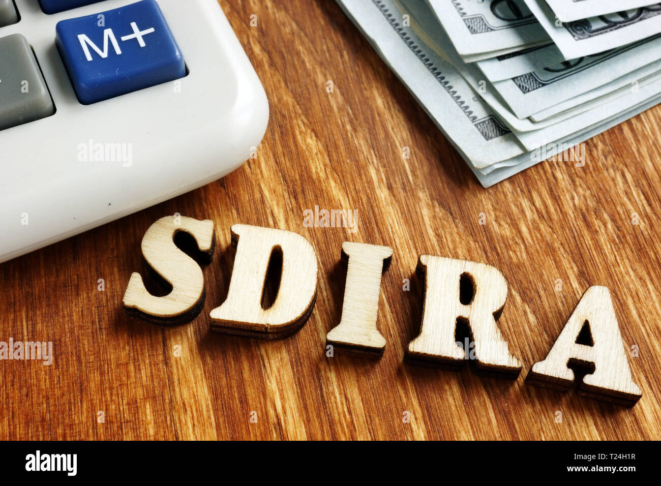 Self Directed IRA - SDIRA wooden letters on desk. Stock Photo