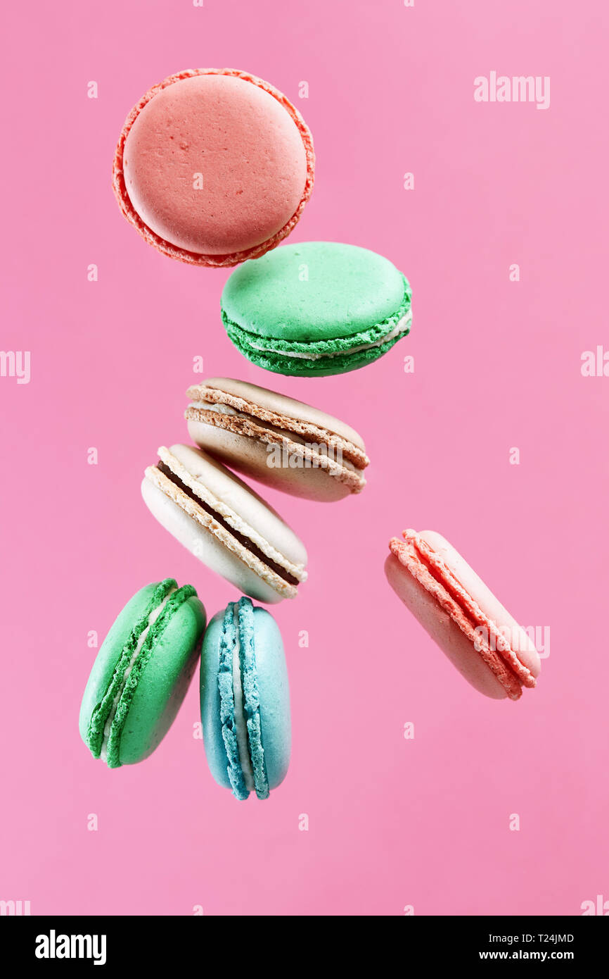 Traditional french colorful macarons on pink background. Stock Photo