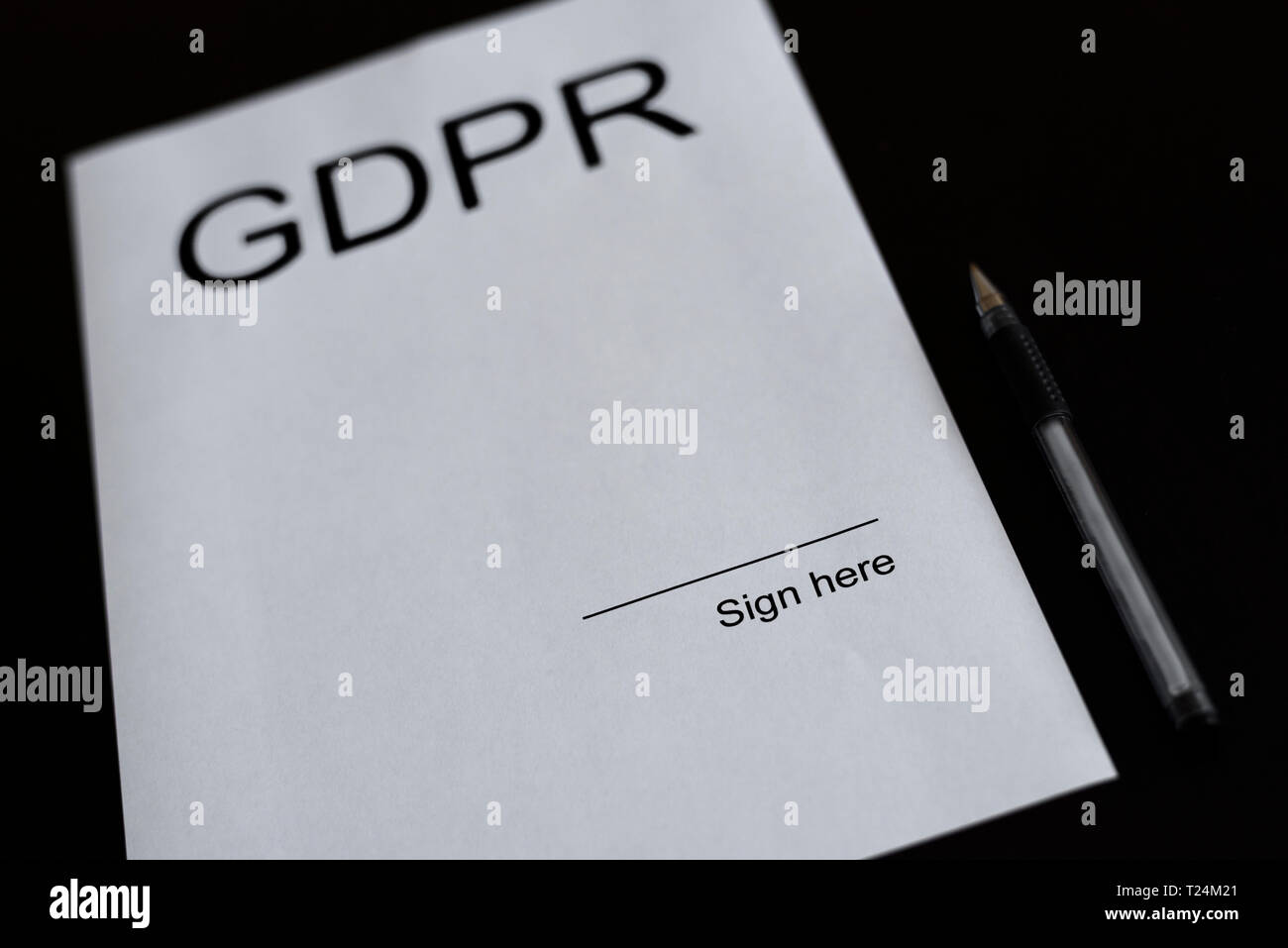 GDPR - General Data Protection Regulation - legislation in European Union about safety. White sheet of paper on the black desk with pen. Blank space o Stock Photo