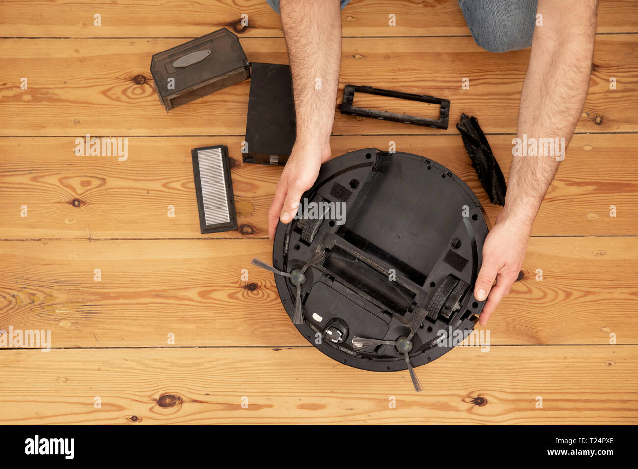 Cleaning the robot vacuum cleaner , robot vacuum cleaner service Stock