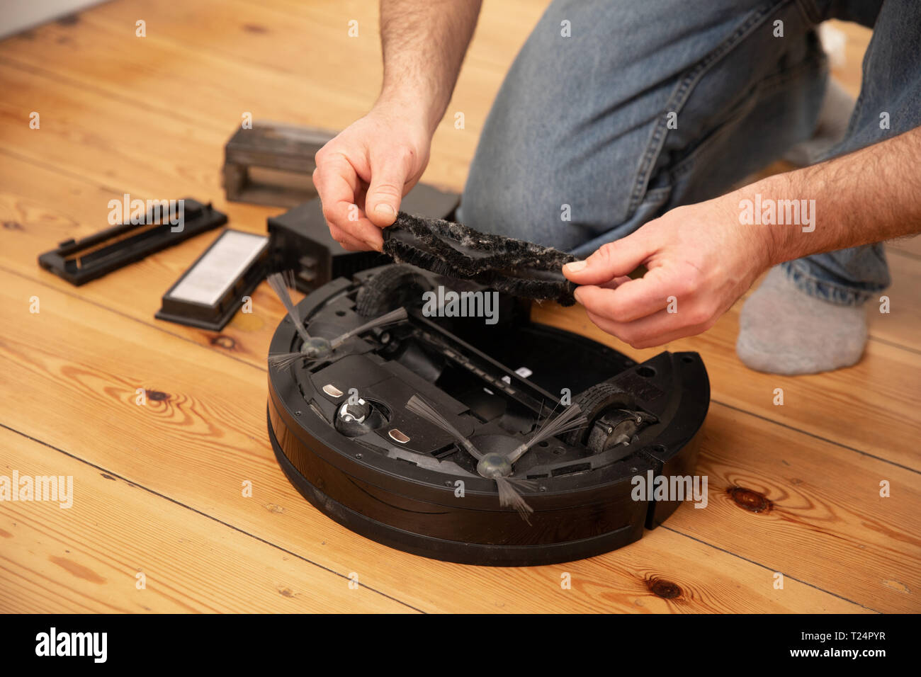 Cleaning the robot vacuum cleaner , robot vacuum cleaner service Stock