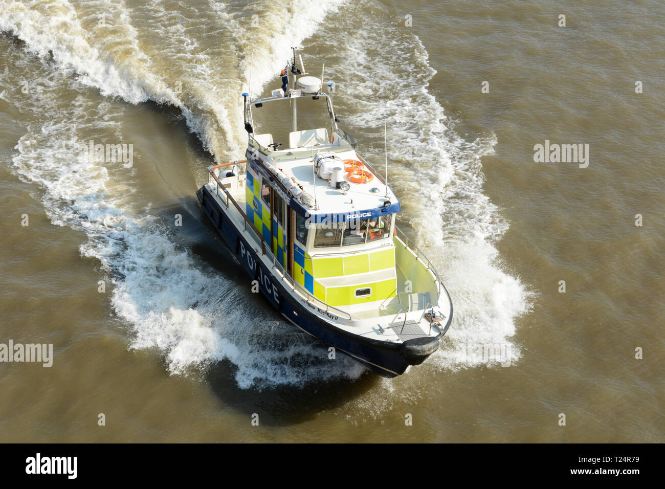 A Thames Division police launch speeding down the River Thames in London, UK Stock Photo