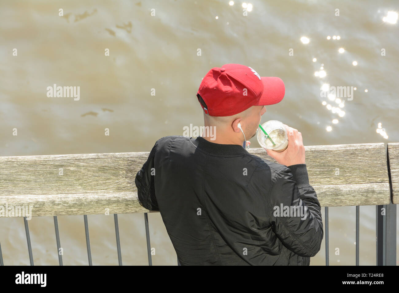 https://c8.alamy.com/comp/T24RE8/a-solitary-man-drinking-an-iced-coffee-and-wearing-a-basball-cap-in-london-uk-T24RE8.jpg