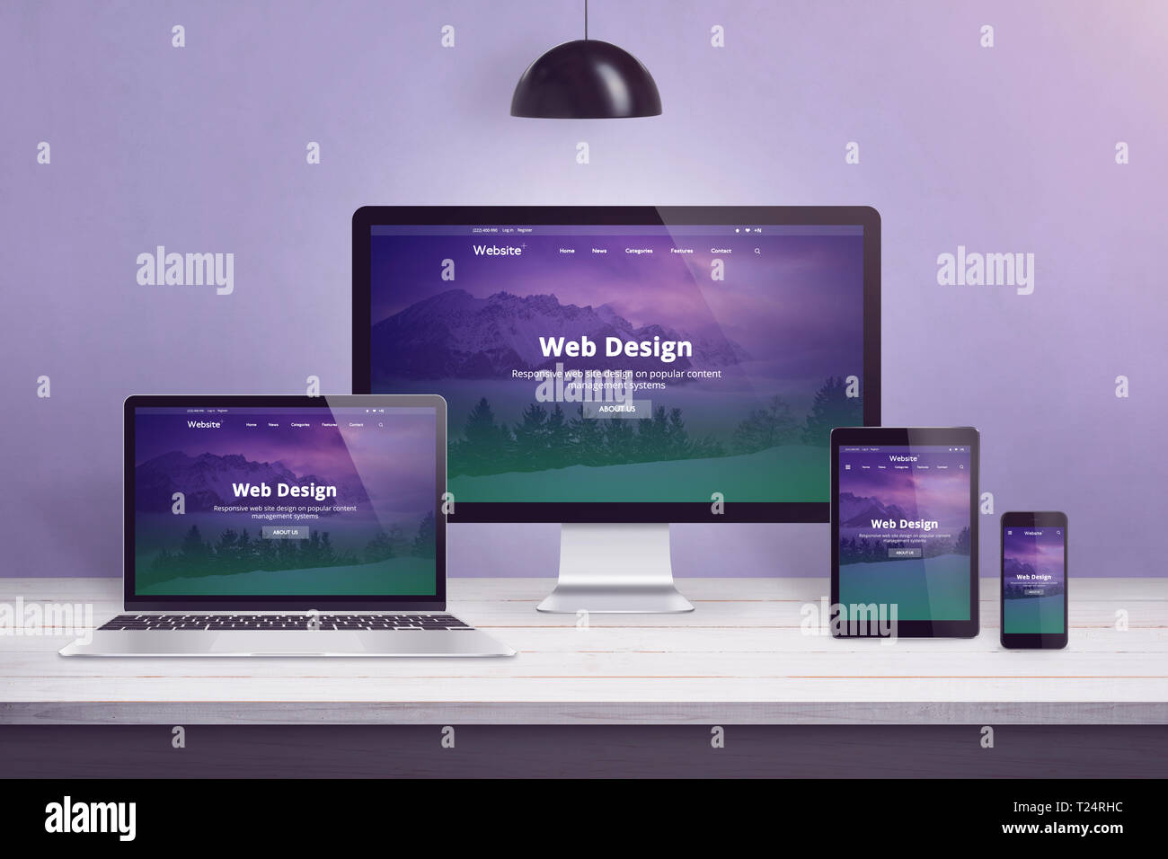 Flat design web site concept on multiple devices. Work desk with laptop, computer display, smart phone and tablet. Purple wall in bacground. Stock Photo