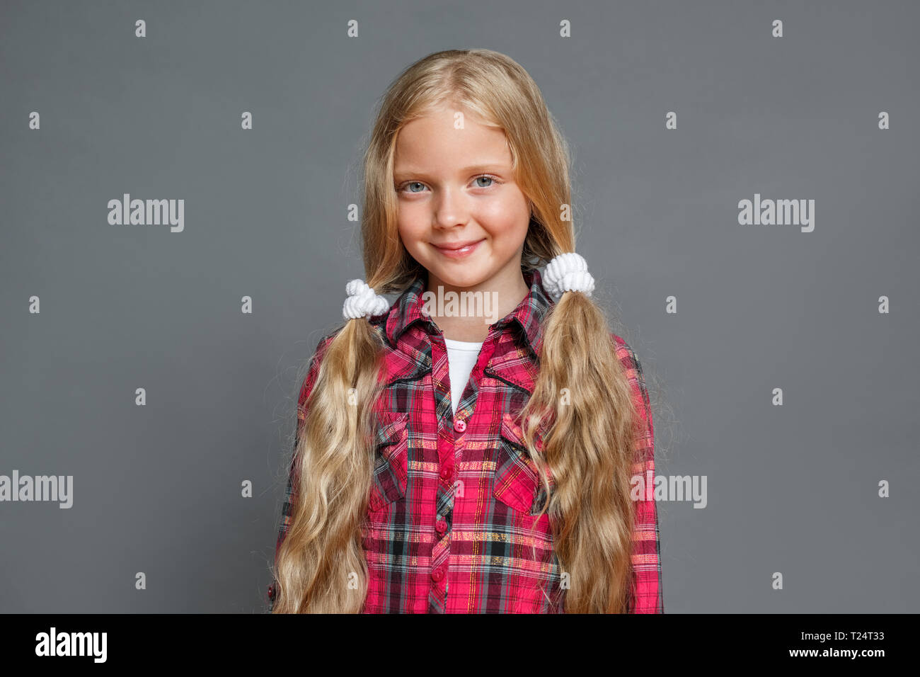 Little Girl With Two Ponytails Studio Standing Isolated On Grey