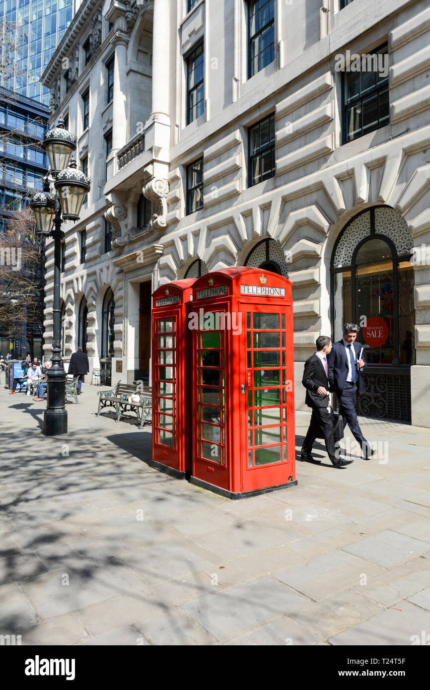 Inoperative Grade II listed red telephone boxes on The Royal Exchange, City of London, UK Stock Photo