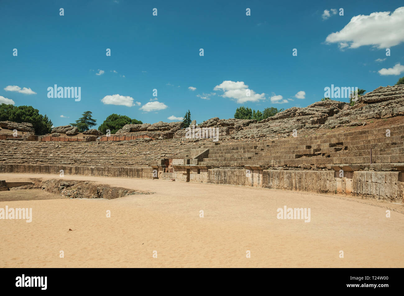 Stone bleachers and arena in the Roman Amphitheater at the archaeological site of Merida. The city preserves many buildings of ancient Rome in Spain. Stock Photo