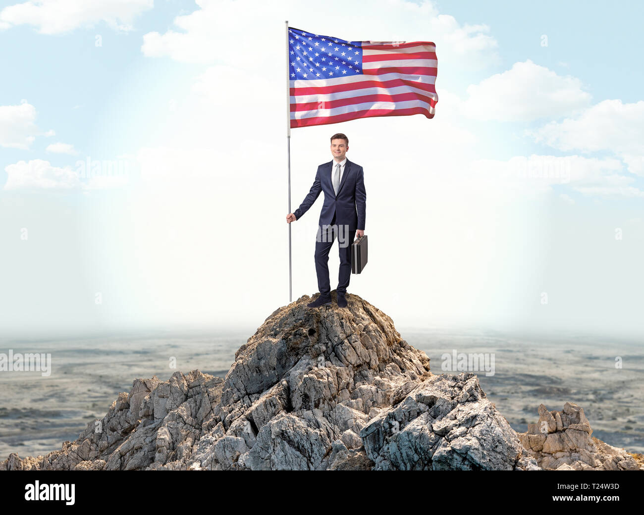 Successful businessman on the top of a mountain holding victory flag ...