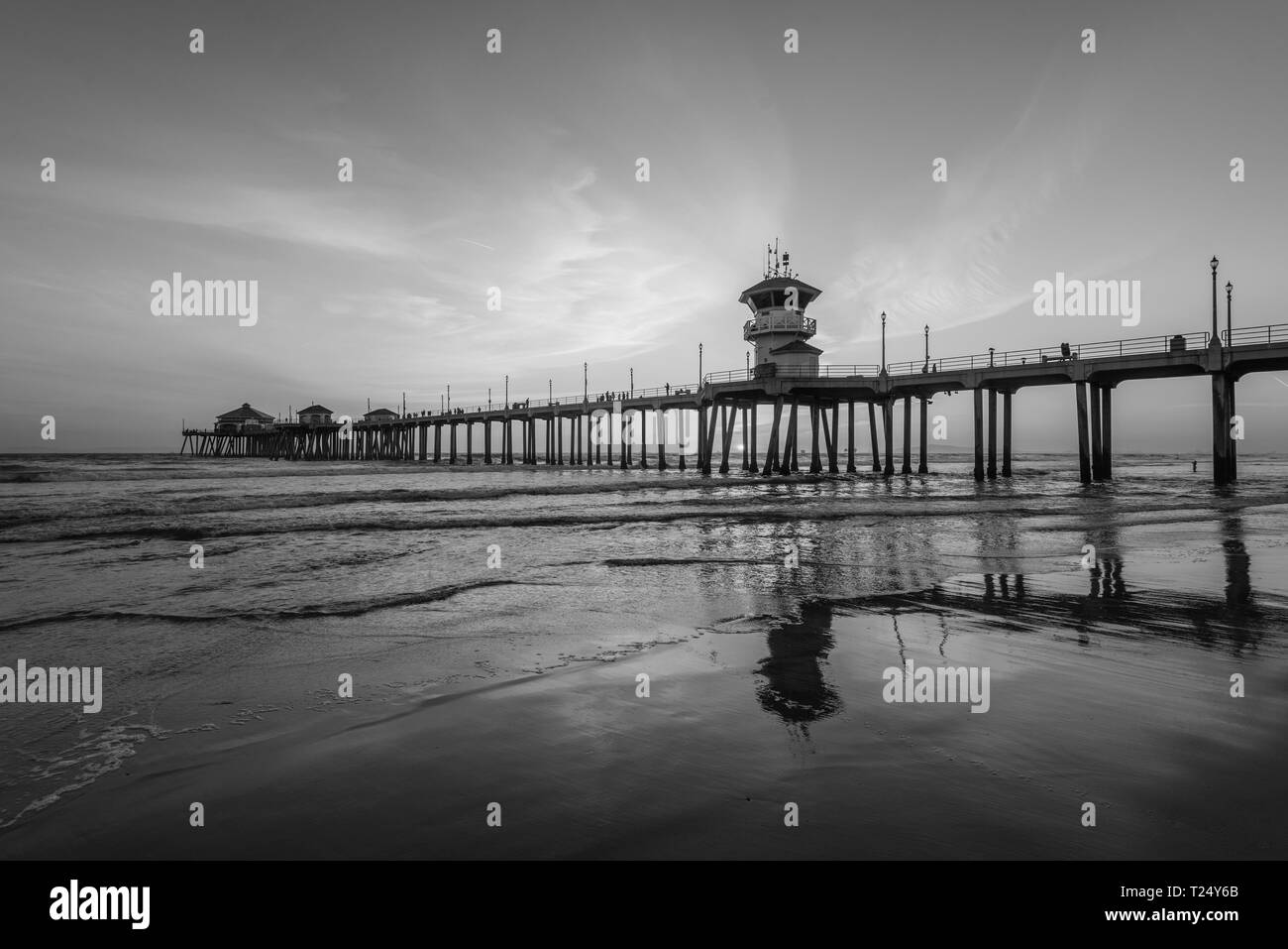 Sunset reflections and the pier in Huntington Beach, Orange County, California Stock Photo