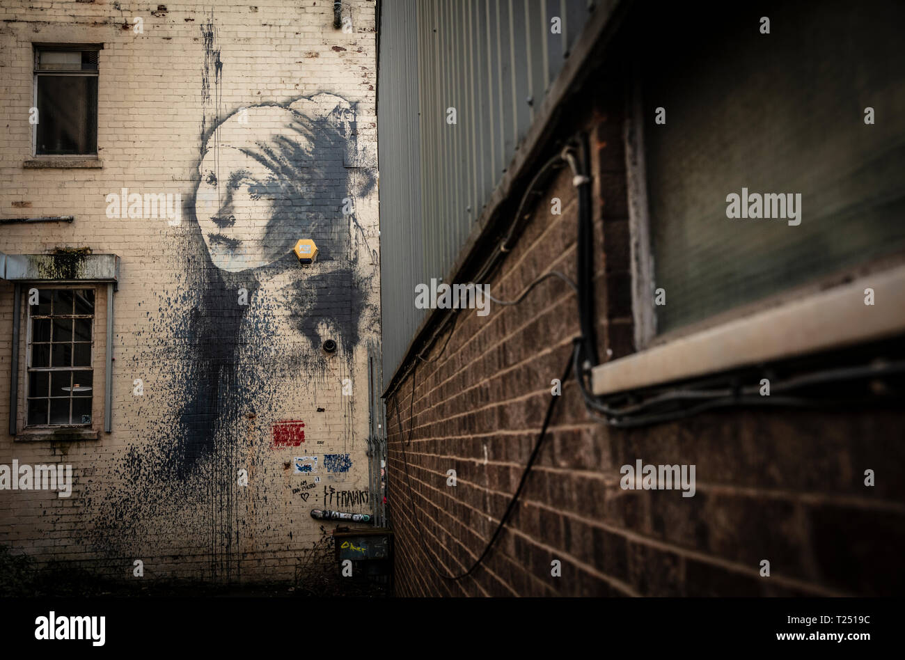 Banksy girl with pierced ear drum hires stock photography and images