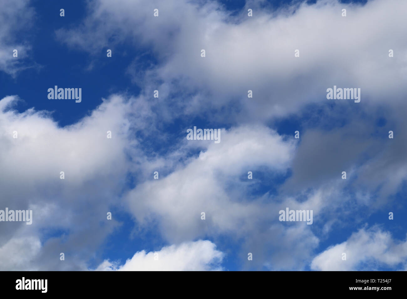 Beautiful blue sky with some white cotton candy clouds during a sunny ...