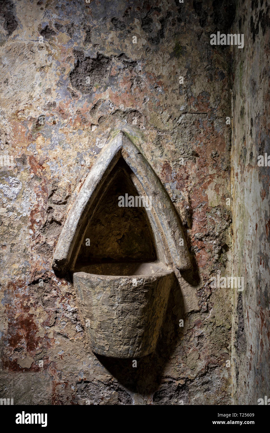 Holy water stoup in a church wall. Stock Photo