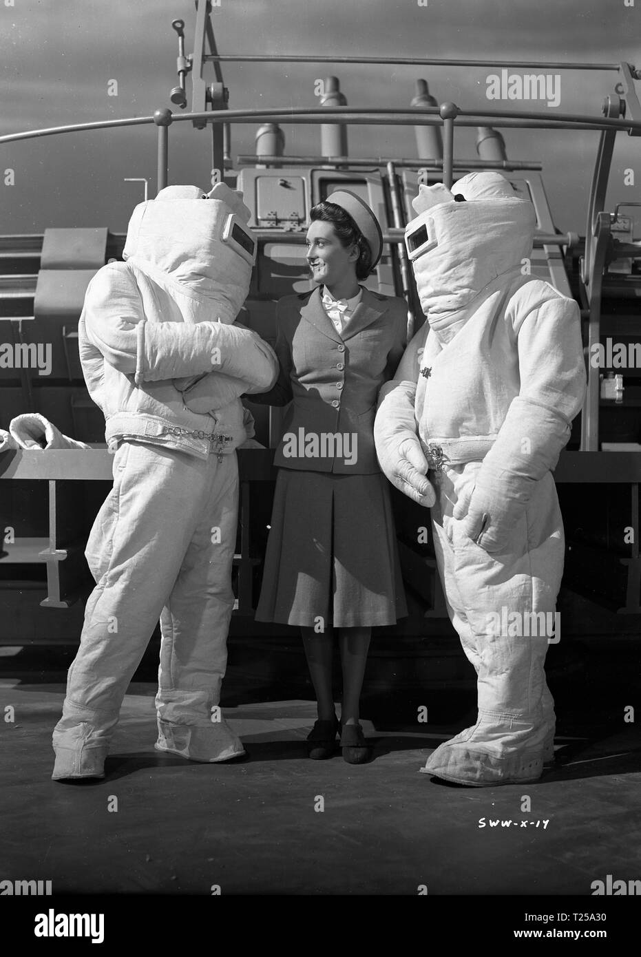 Ships with Wings (1941) Jane Baxter with two sailors in fire resistant suits     Date: 1941 Stock Photo