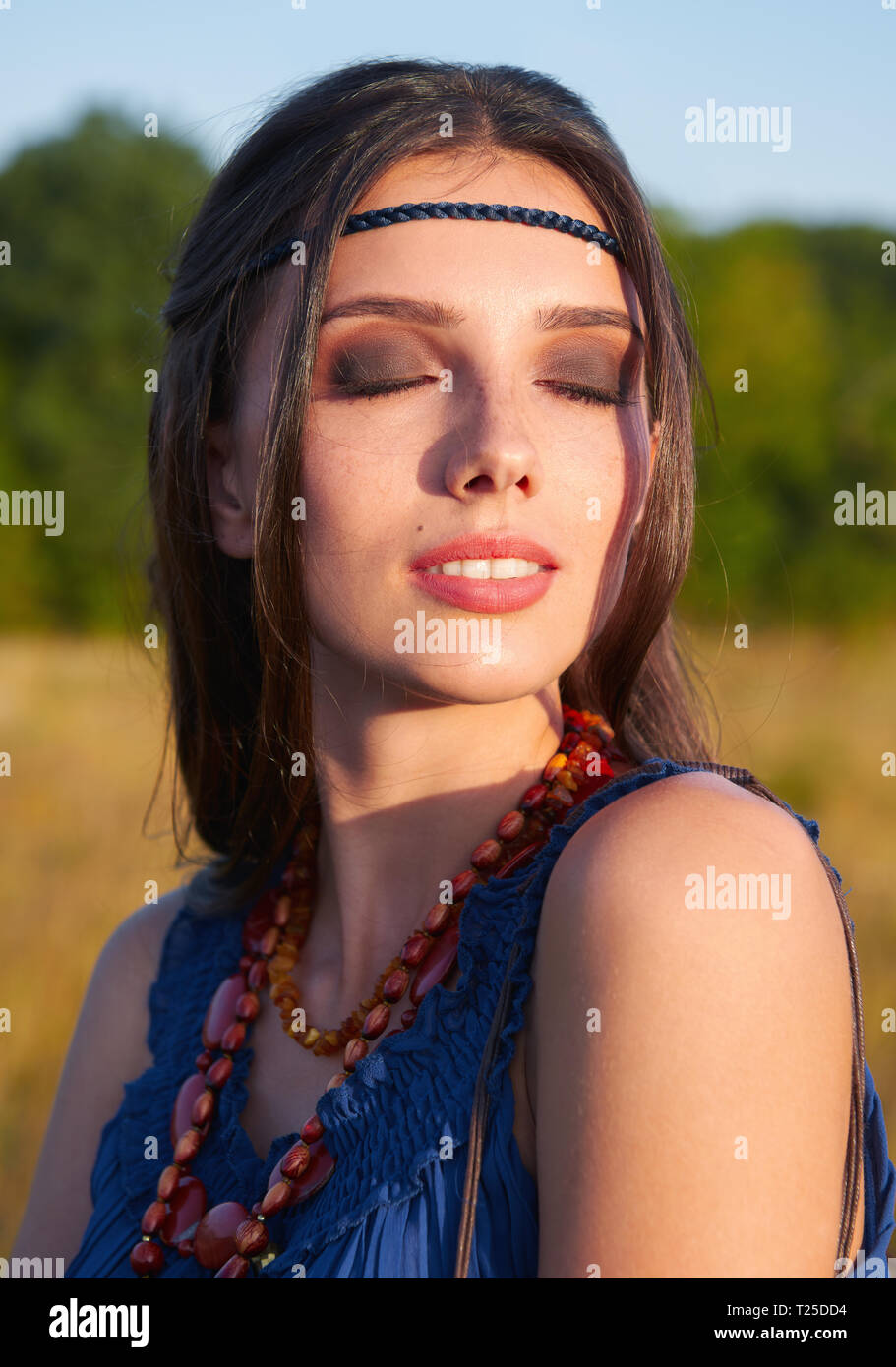 Close-up outdoor portrait of the lovely young boho (hippie) girl with closed eyes Stock Photo