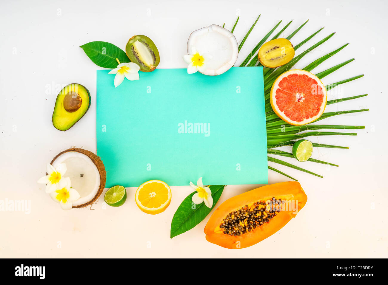 fresh fruits slices and green leaves tropical flat lay scene, summer ...