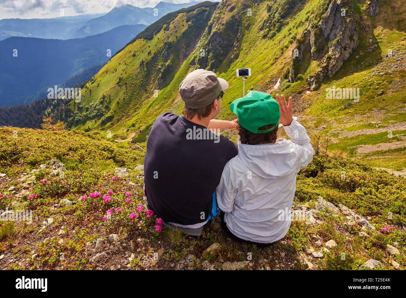Young couple hiking taking selfie with smart phone. Happy young man and ...