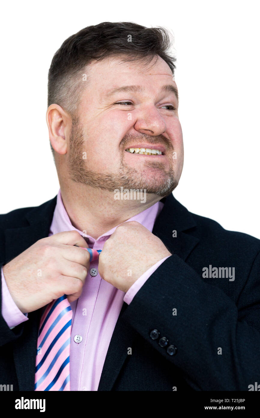 Angry fat man with a beard stretches removes his tie from his neck. Stock Photo