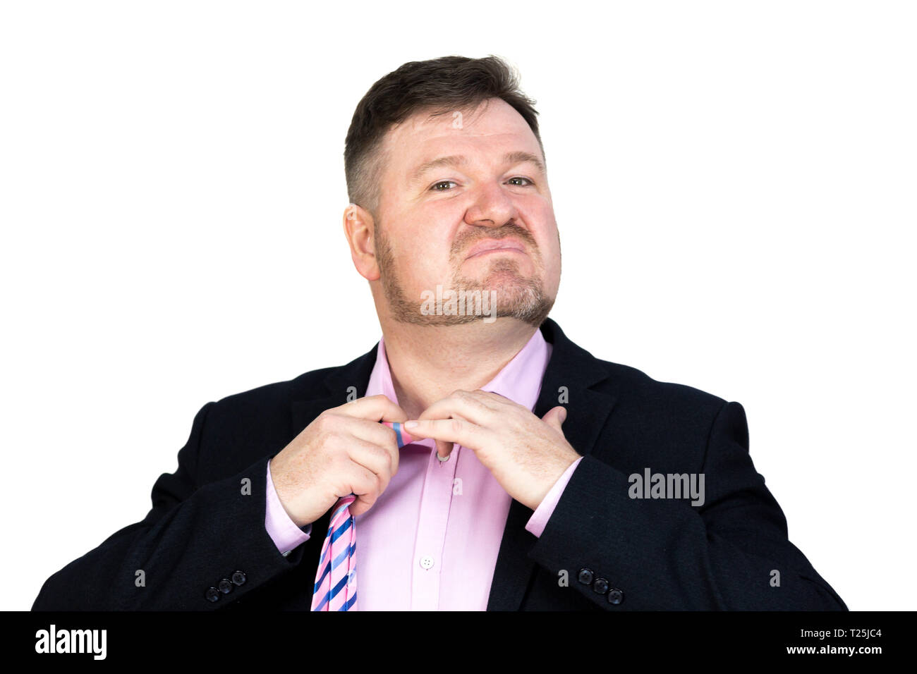 Angry fat man with a beard, stretches removes his tie from his neck. Stock Photo