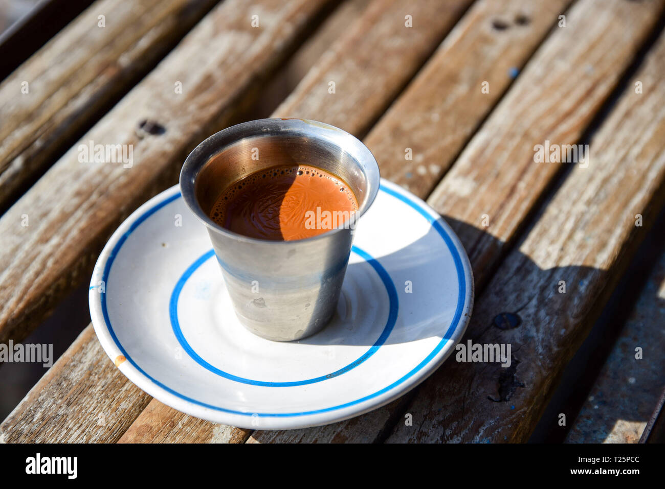 Cup of hot Indian style tea or chai on wooden desk in Rajkot, Gujarat