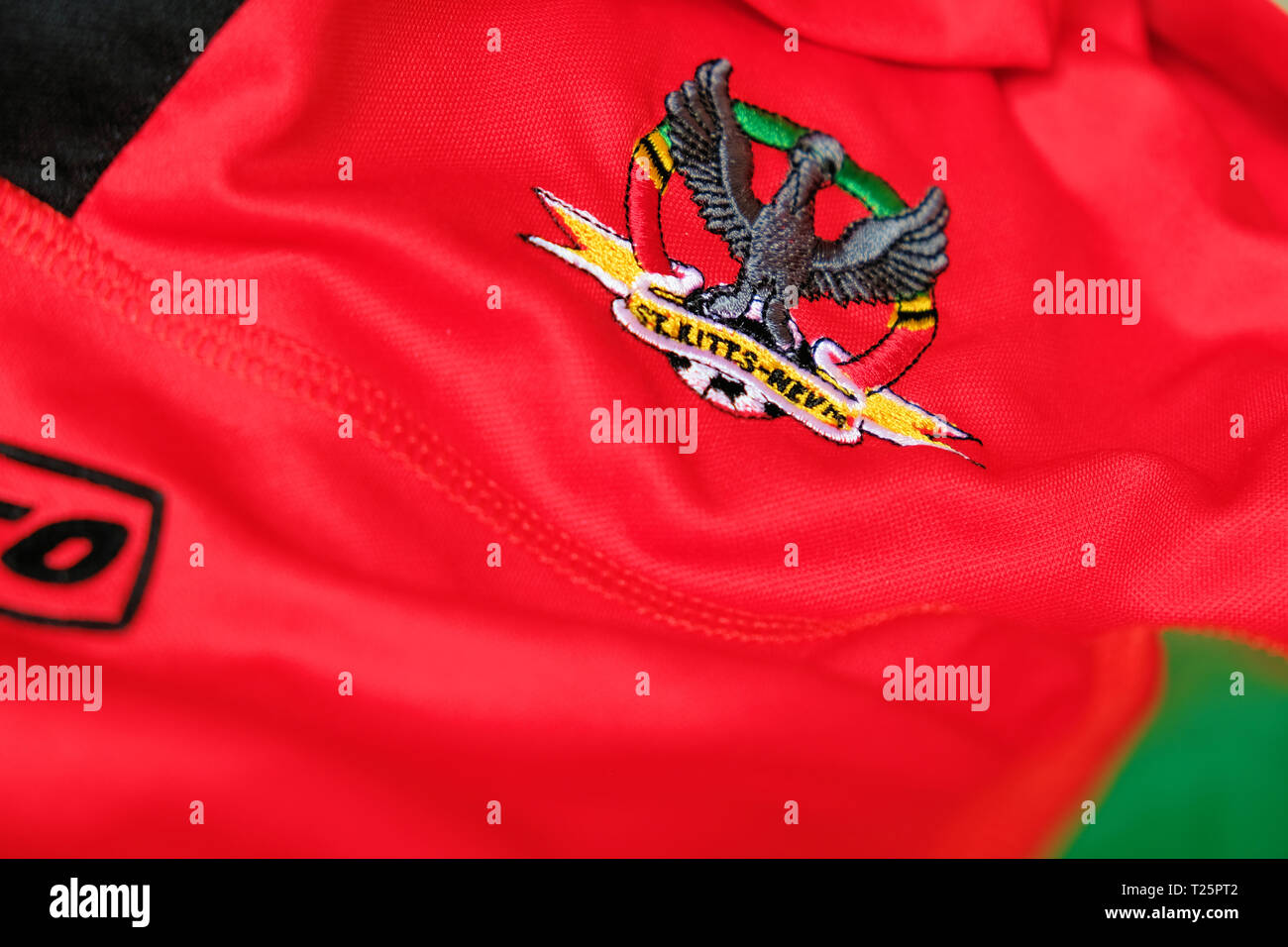 Logo on national soccer team jersey for the Saint Kitts and Nevis national football team; St. Kitts & Nevis national team kit. Stock Photo