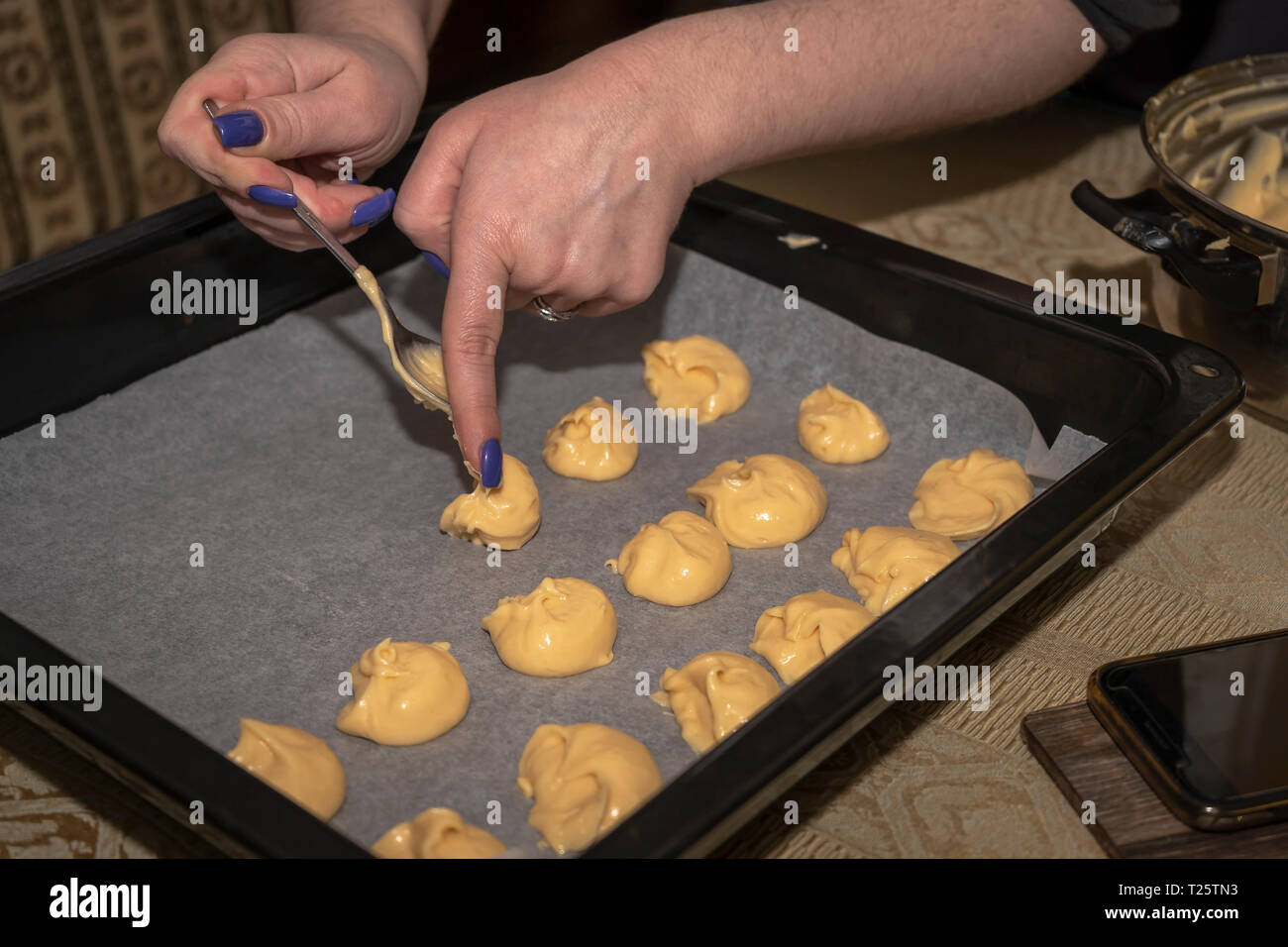 Puff pastry for cake spoonfuls in a baking tray in an electric oven