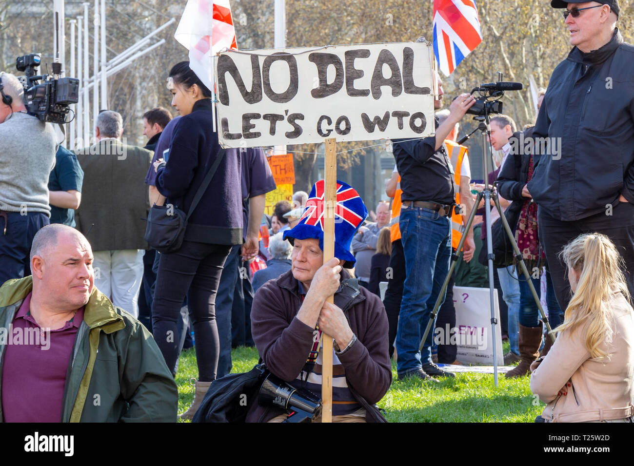 Westminster, London, UK; 29th March 2019; Male Pro-Brexit Demonstrator With Home Made Sign and Wearing Union Jack Hat Seated During Protest Rally Stock Photo