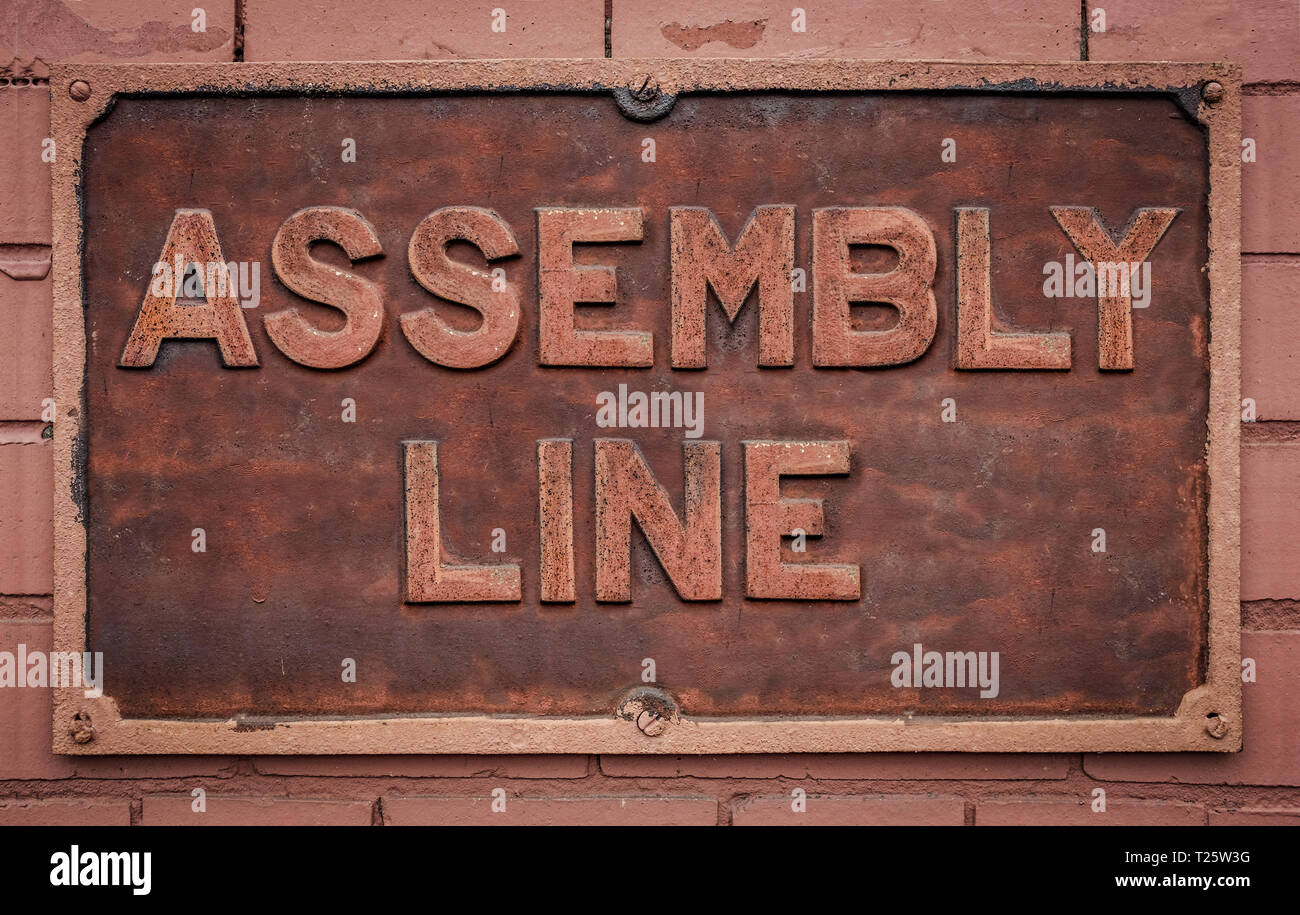 A Grungy Metal Sign For A Manufacturing Assembly Line Stock Photo
