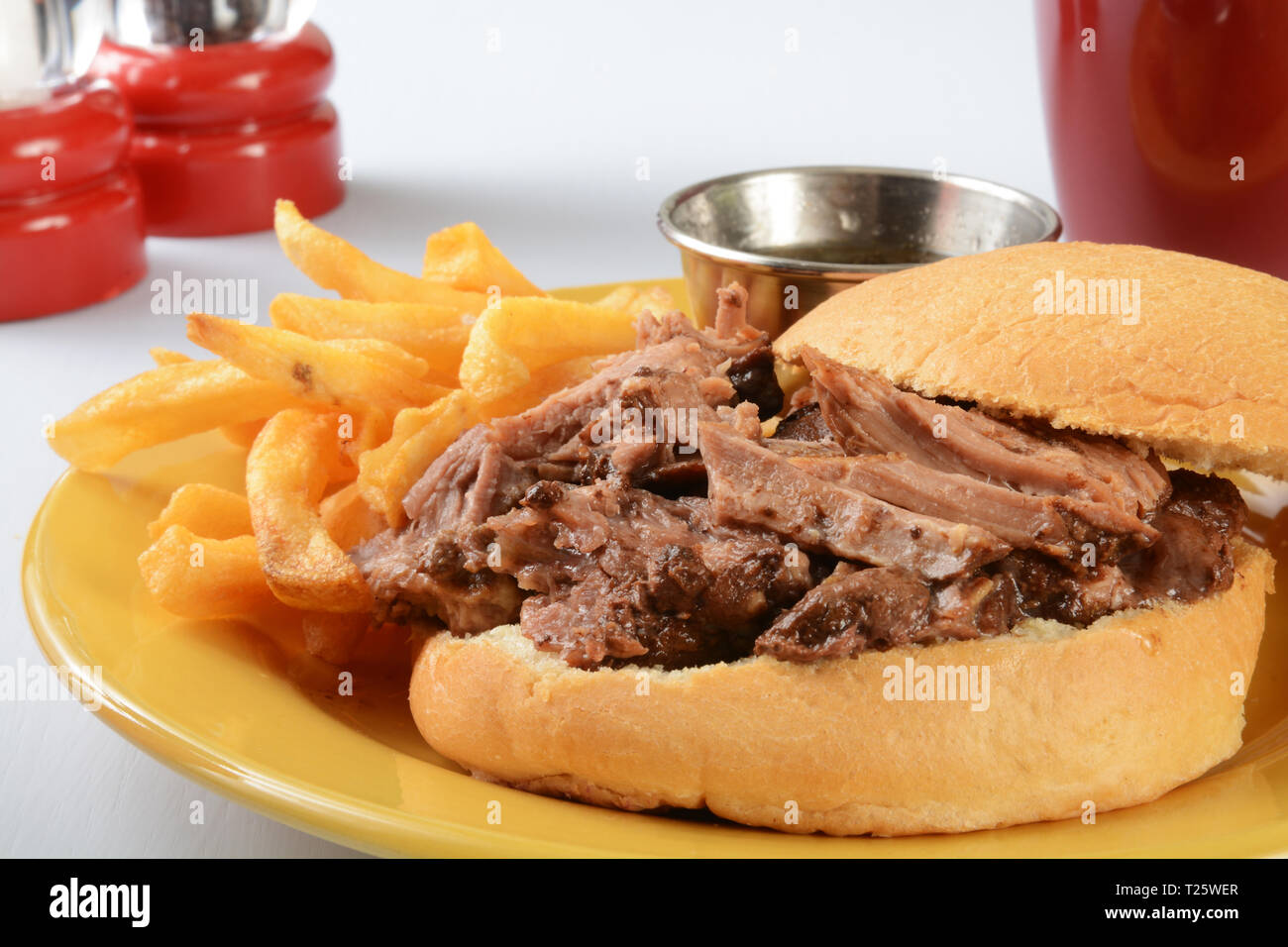A roast beef au jus sandwich with french fries Stock Photo Alamy