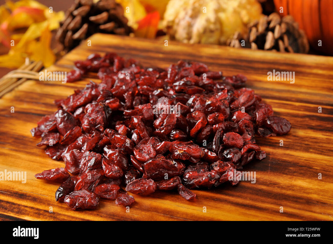 Dried Cranberries On A Cutting Board With Holiday Decorations In