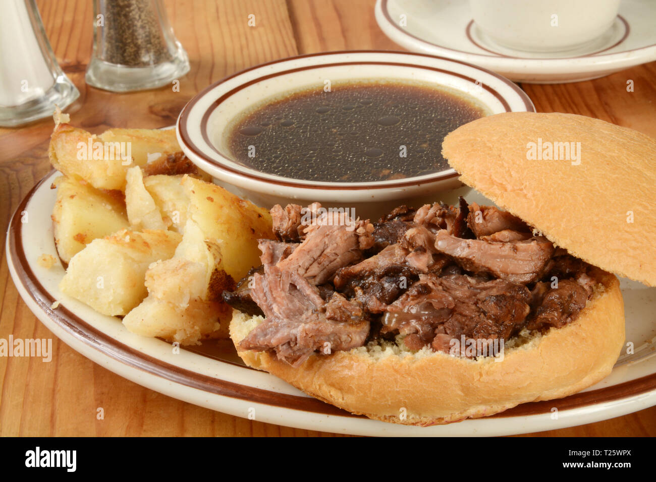 A roast beef sandwich au jus with home fried potatoes Stock Photo Alamy