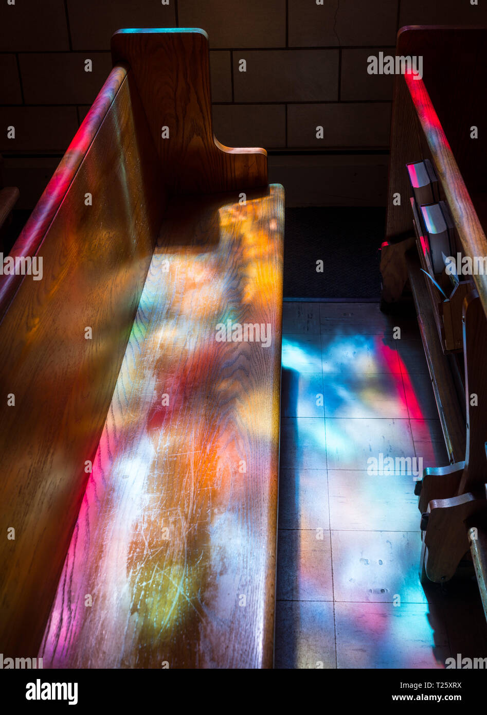 Light rays from stained glass window light up church aisle Stock Photo Alamy