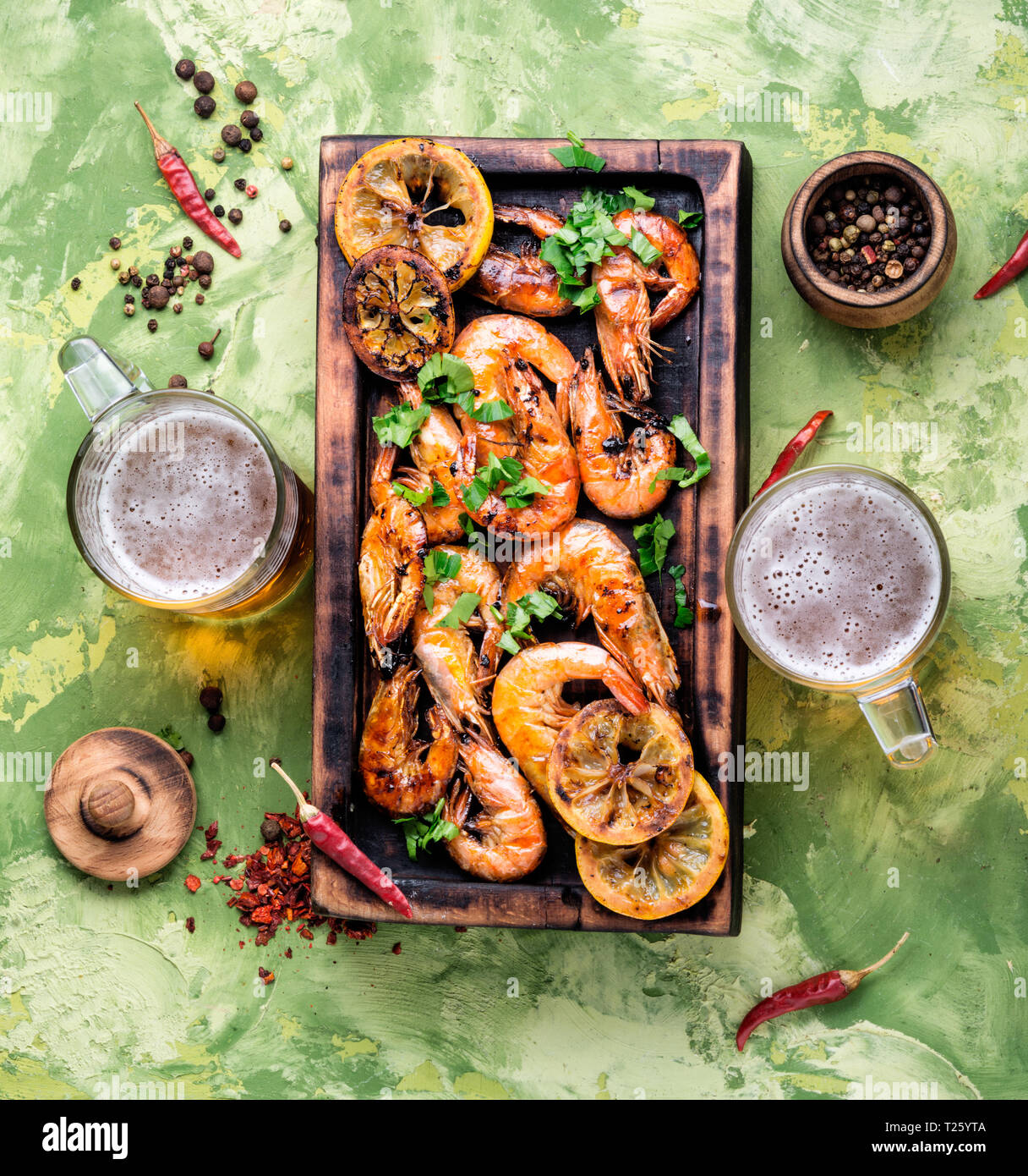 Grilled shrimps on a wooden kitchen board. Delicious seafood.Barbecue srimps prawns Stock Photo