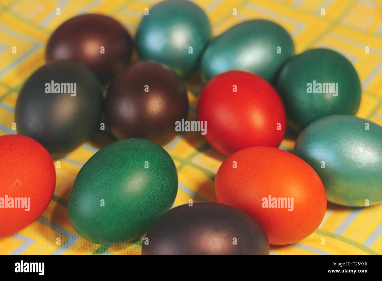 Multicolored painted eggs in the basket close up. Stock Photo