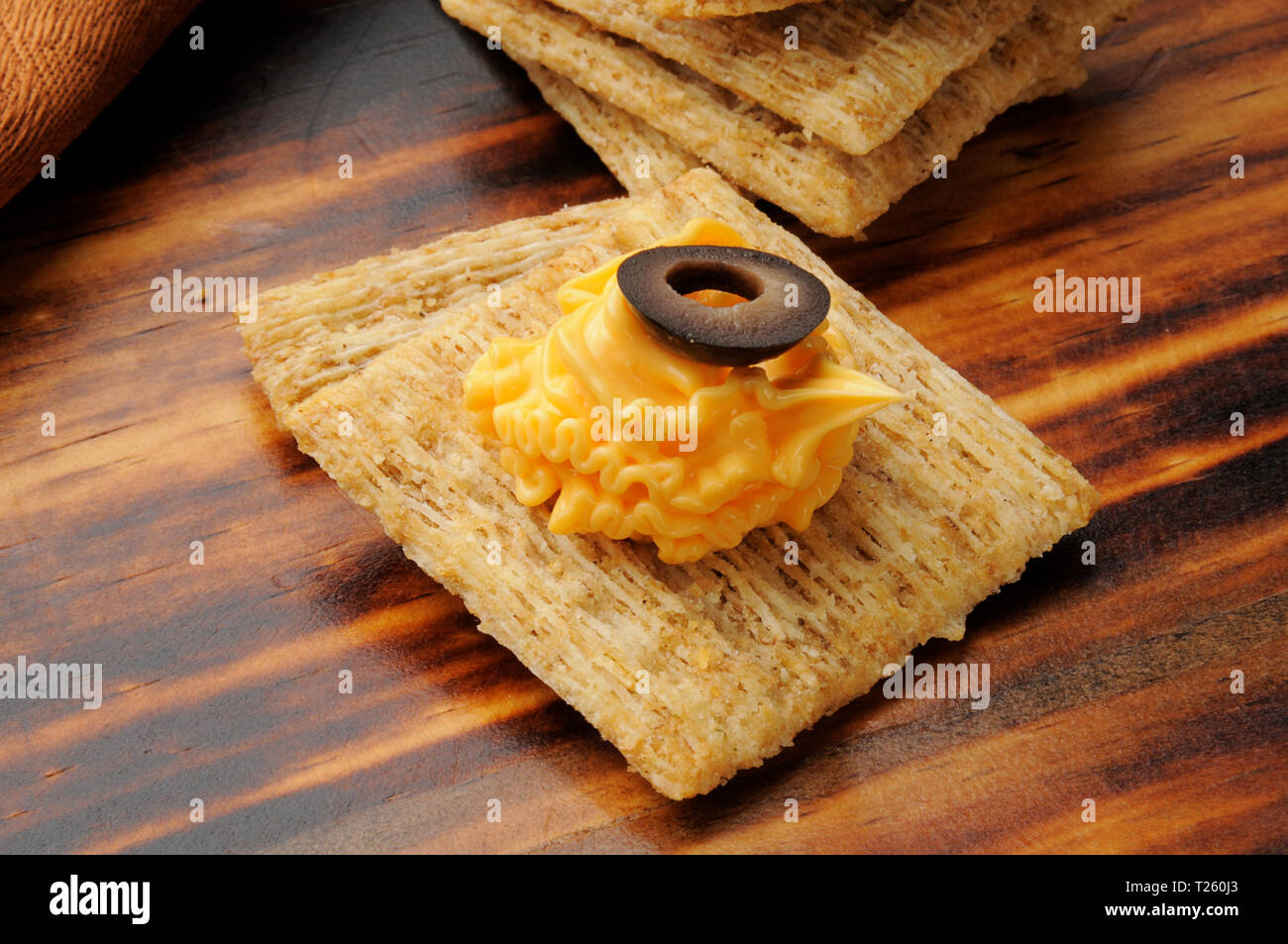 Whole wheat crackers with cheese and an olive slice Stock Photo Alamy