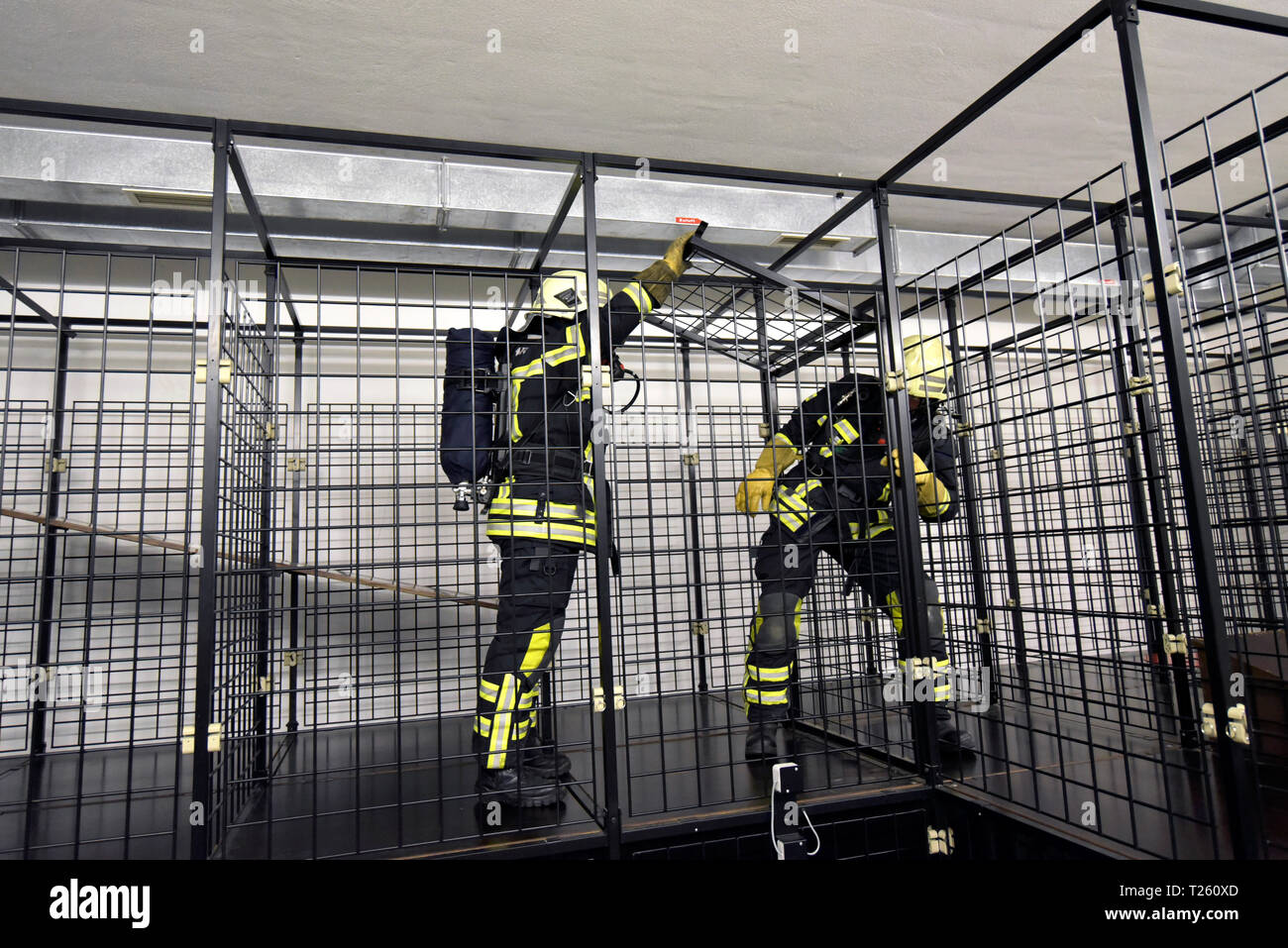 Two firefighters with respirator and air tank exercising Stock Photo