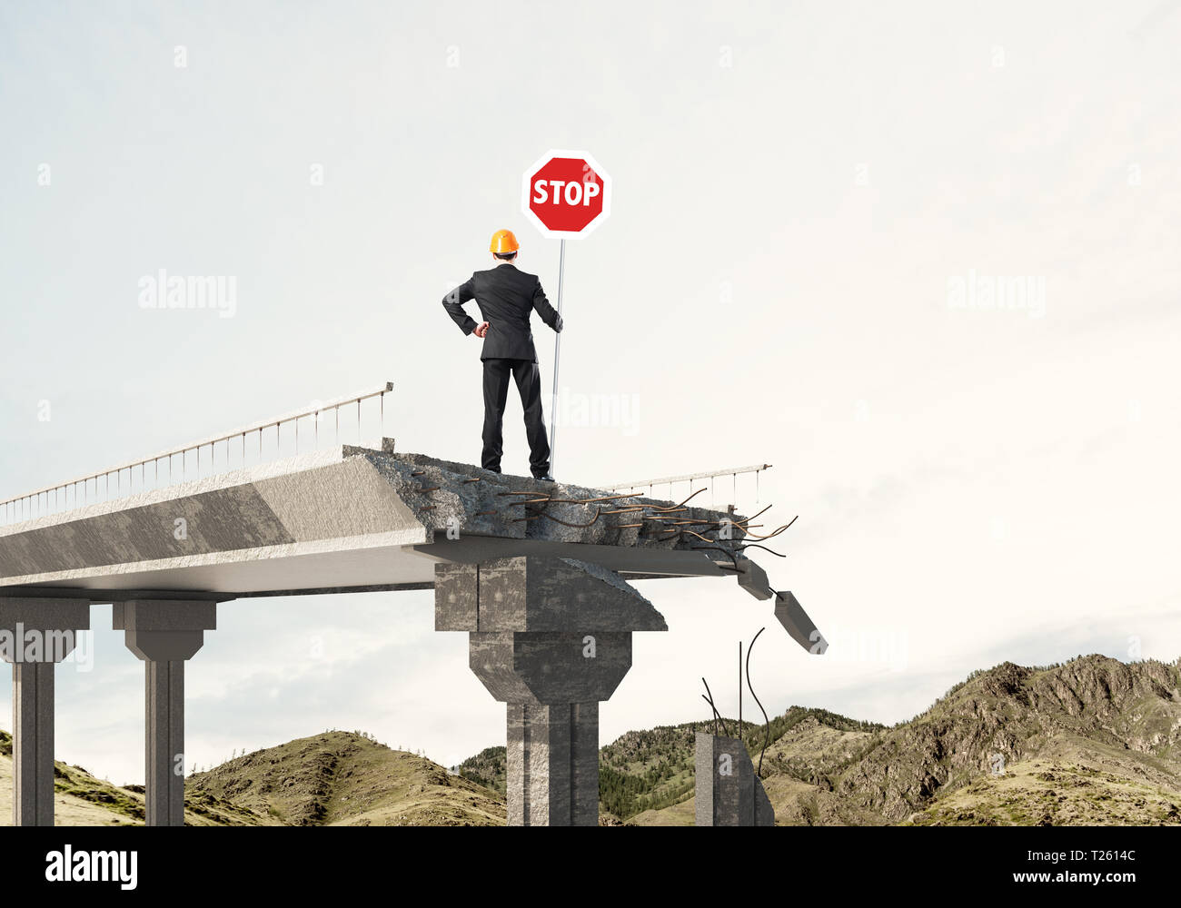 Rear view of engineer in helmet holding stop sign while standing on ...