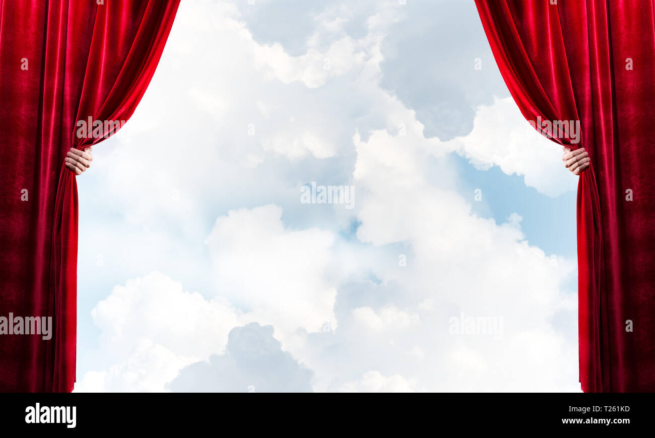 Human hand opens red velvet curtain on blue sky background Stock Photo ...