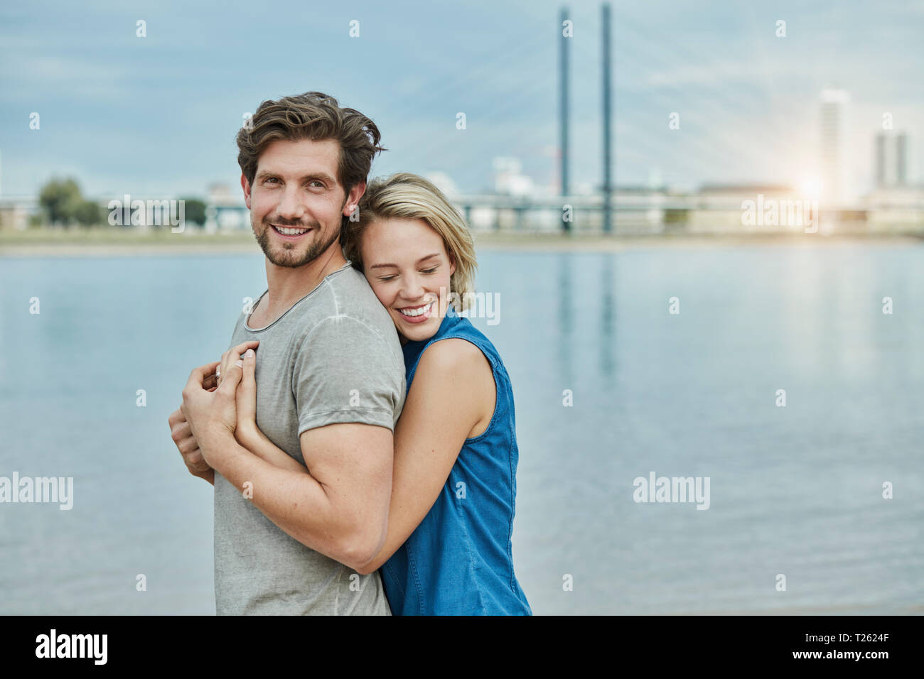 Happy young couple hugging hi-res stock photography and images - Alamy