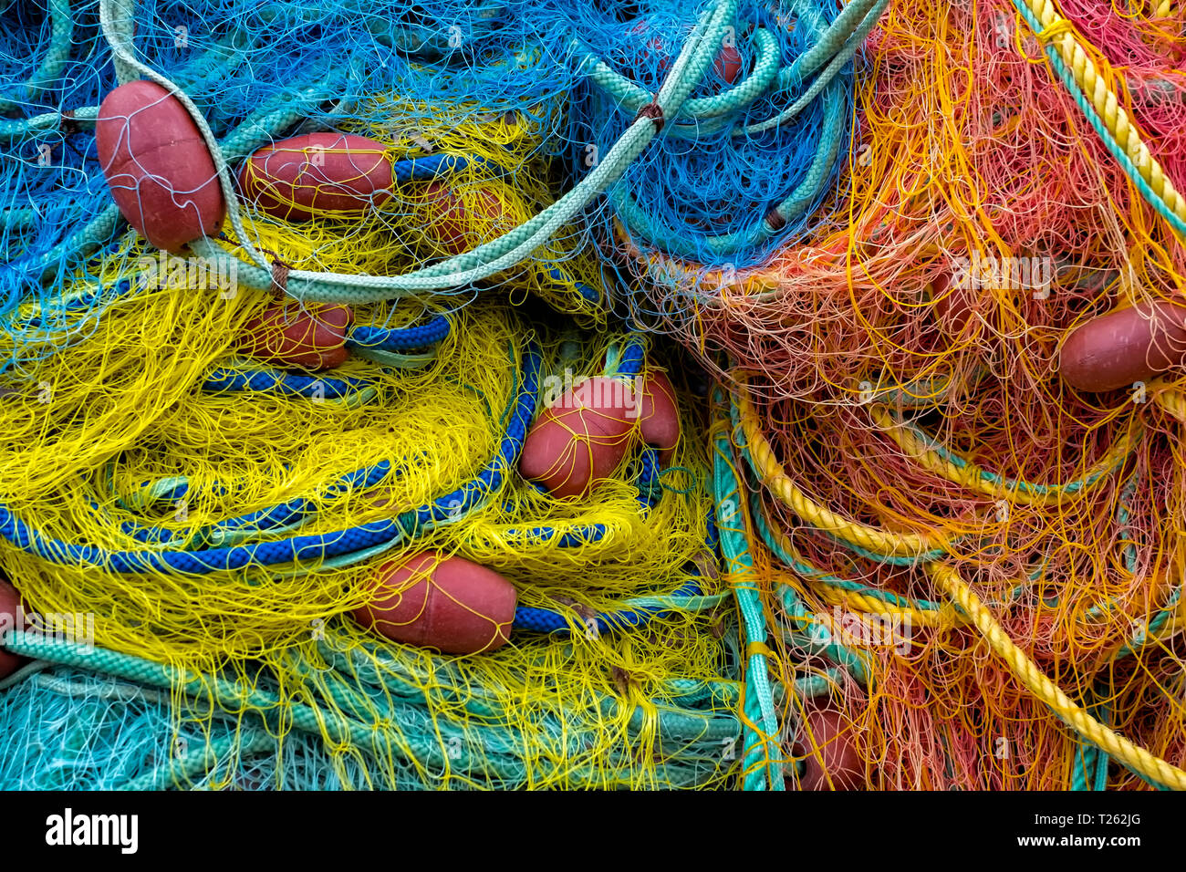 Colourful fishing nets with red buoys Stock Photo
